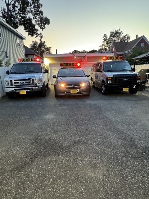 RMJ Transportation LLC vehicles with school bus signage and safety lights